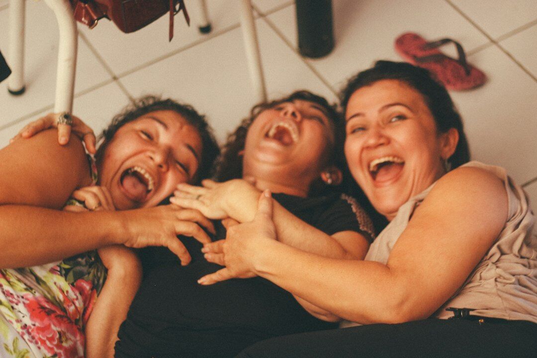 Group of colleagues laughing together in an office