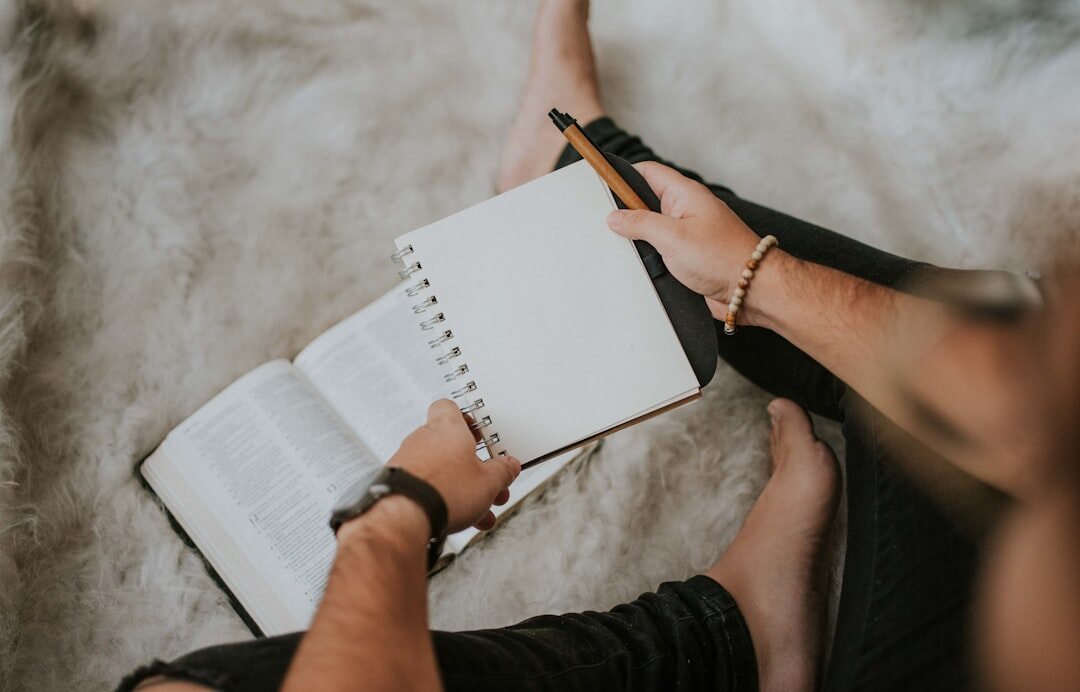 Person taking notes on a notebook during a business discussion